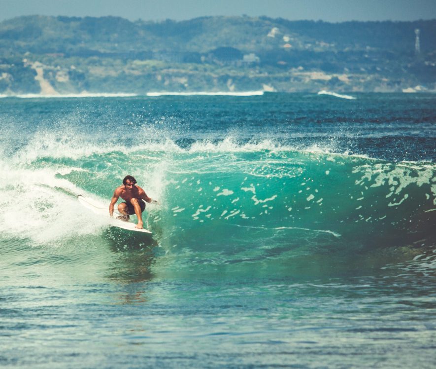 Men and girls surf the island of Bali